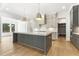 Kitchen featuring gray cabinets, a spacious island with a countertop, and stainless steel appliances at 43 Laurel Knoll Dr, Pittsboro, NC 27312
