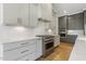 Kitchen with white cabinets, stainless steel appliances, and an elegant marble countertop at 43 Laurel Knoll Dr, Pittsboro, NC 27312