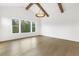 Bright living room with hardwood floors, large windows, and decorative ceiling fixture at 43 Laurel Knoll Dr, Pittsboro, NC 27312