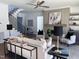 Open-concept living room featuring a fireplace, staircase, modern decor, and plenty of seating at 43 Laurel Knoll Dr, Pittsboro, NC 27312