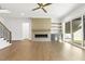 Bright living room with hardwood floors, modern fireplace, built-in shelving, and staircase at 43 Laurel Knoll Dr, Pittsboro, NC 27312