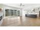 Spacious living room with hardwood floors, fireplace, and sliding glass doors to a screened porch at 43 Laurel Knoll Dr, Pittsboro, NC 27312