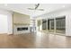 Bright living room with a fireplace, built-in shelving, hardwood floors, and large sliding glass doors at 43 Laurel Knoll Dr, Pittsboro, NC 27312