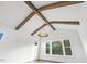 Living room features hardwood floors, large windows, beams on the ceiling and a decorative light fixture at 43 Laurel Knoll Dr, Pittsboro, NC 27312