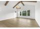 Bright living room with hardwood floors, large windows, and a decorative ceiling fixture at 43 Laurel Knoll Dr, Pittsboro, NC 27312