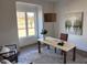 Bright home office with a large window, stylish decor, and hardwood flooring at 43 Laurel Knoll Dr, Pittsboro, NC 27312