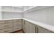Pantry features gray cabinets, quartz counters, white tile backsplash, and open shelving at 43 Laurel Knoll Dr, Pittsboro, NC 27312