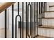 Close up on the staircase with wood handrail and black metal spindles at 43 Laurel Knoll Dr, Pittsboro, NC 27312
