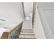 Upward view of the staircase with wood handrail and black metal spindles at 43 Laurel Knoll Dr, Pittsboro, NC 27312