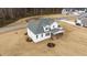 A lush landscape surrounds a two-story house with a screened-in porch near a tranquil pond at 125 Cotton Fields Ln # 26, Fuquay Varina, NC 27526