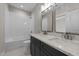 Bathroom with double vanity with quartz countertops, subway tiled shower and patterned tile floor at 125 Cotton Fields Ln # 26, Fuquay Varina, NC 27526