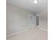 Neutral carpeted bedroom with a ceiling light, white trim, and a closet for ample storage at 125 Cotton Fields Ln # 26, Fuquay Varina, NC 27526