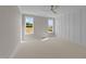 Bright bedroom featuring neutral carpeting, a ceiling fan, and two windows that offer natural light at 125 Cotton Fields Ln # 26, Fuquay Varina, NC 27526