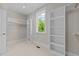 Bright walk-in closet features built-in shelving and a window offering natural light at 125 Cotton Fields Ln # 26, Fuquay Varina, NC 27526