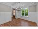 Dining room features hardwood floors, a modern chandelier, white wainscoting, and a coffered ceiling at 125 Cotton Fields Ln # 26, Fuquay Varina, NC 27526