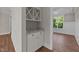Dining room features hardwood floors, a modern chandelier, white wainscoting, and built-in wine storage at 125 Cotton Fields Ln # 26, Fuquay Varina, NC 27526