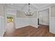 Dining room features hardwood floors, a modern chandelier, white wainscoting, and a coffered ceiling at 125 Cotton Fields Ln # 26, Fuquay Varina, NC 27526