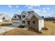 Beautiful new construction features a stone and white accent exterior, large garage and well manicured lawn at 125 Cotton Fields Ln # 26, Fuquay Varina, NC 27526