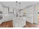 Modern kitchen with white cabinetry, granite countertops, stainless steel appliances, and wood-look flooring at 125 Cotton Fields Ln # 26, Fuquay Varina, NC 27526