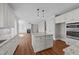 Open-concept kitchen with island, stainless appliances, white cabinetry, and a view to the living room at 125 Cotton Fields Ln # 26, Fuquay Varina, NC 27526