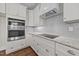 Well-appointed kitchen featuring granite countertops, white cabinetry, subway tile backsplash, and stainless steel appliances at 125 Cotton Fields Ln # 26, Fuquay Varina, NC 27526