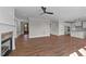 Open living space with a fireplace, wood-look floors, connecting the entry, kitchen, and dining areas for seamless living at 125 Cotton Fields Ln # 26, Fuquay Varina, NC 27526