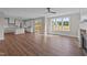 Bright and airy living room featuring wood floors, large windows with great views, and easy access to the kitchen and deck at 125 Cotton Fields Ln # 26, Fuquay Varina, NC 27526