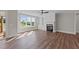 Cozy living area with a fireplace, built-in shelving, and large windows offering serene views of the surrounding landscape at 125 Cotton Fields Ln # 26, Fuquay Varina, NC 27526
