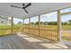 Screened-in porch with wooden floors and ceiling fan, perfect for outdoor relaxation at 125 Cotton Fields Ln # 26, Fuquay Varina, NC 27526