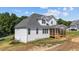 A white house with a screened in porch and many windows for natural lighting at 125 Cotton Fields Ln # 26, Fuquay Varina, NC 27526