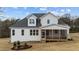 A white two-story home boasting a screened-in porch, perfect for enjoying the outdoors at 125 Cotton Fields Ln # 26, Fuquay Varina, NC 27526