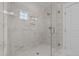 Bathroom shower with glass door, white marble tile, rainfall showerhead, and built-in niche at 125 Cotton Fields Ln # 26, Fuquay Varina, NC 27526