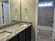 Bathroom showcasing granite countertops, double sink vanity, and a tiled shower/bathtub at 98 Prency Ln, Middlesex, NC 27557
