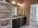 Bathroom featuring double sink vanity with granite countertops, white orchids, and view into walk-in closet at 98 Prency Ln, Middlesex, NC 27557