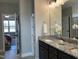 Stylish bathroom featuring double vanity with granite countertop, modern fixtures, and decorative white flower at 98 Prency Ln, Middlesex, NC 27557