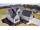 New two-story home with white siding, dark shutters and roof, and a two-car garage at 98 Prency Ln, Middlesex, NC 27557