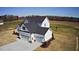 Aerial view of a newly constructed two-story home featuring a 3-car garage, with white siding and a dark roof at 98 Prency Ln, Middlesex, NC 27557