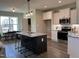 Open kitchen boasts a center island with seating, modern stainless appliances, and white shaker cabinets at 98 Prency Ln, Middlesex, NC 27557