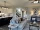 Living room with contemporary decor, leading into a kitchen with a large island and white cabinets at 98 Prency Ln, Middlesex, NC 27557