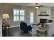 Bright and airy living room with a fireplace and large windows overlooking the backyard at 98 Prency Ln, Middlesex, NC 27557