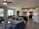 Open-concept living room and kitchen area features modern appliances and a spacious island with seating at 98 Prency Ln, Middlesex, NC 27557
