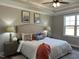Serene main bedroom with tray ceiling, featuring ample space and natural light from a large window at 98 Prency Ln, Middlesex, NC 27557