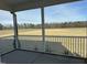 Covered patio offering serene views of a vast field and distant trees, perfect for relaxation and outdoor living at 98 Prency Ln, Middlesex, NC 27557