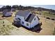 New two-story home with white siding and a dark roof; features a screened porch and level lot at 98 Prency Ln, Middlesex, NC 27557