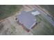 Aerial view of back of the home showing back yard, driveway, landscaping, and HVAC units at 27 Prency Ln, Middlesex, NC 27557