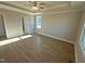 Large bedroom with tray ceilings, crown molding, a ceiling fan, and a large window at 27 Prency Ln, Middlesex, NC 27557