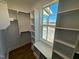 Well-organized walk-in closet features custom shelving and a window seat at 27 Prency Ln, Middlesex, NC 27557
