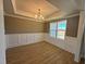 Bright dining room features wood floors, wainscoting, crown molding, and a large window at 27 Prency Ln, Middlesex, NC 27557