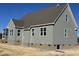 Side view of new construction house showing gray siding and windows at 27 Prency Ln, Middlesex, NC 27557