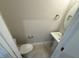A pedestal sink and toilet in a small powder room with light colored walls and tile flooring at 27 Prency Ln, Middlesex, NC 27557